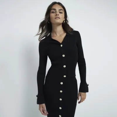 Black knit button detail polo top sold by River Island