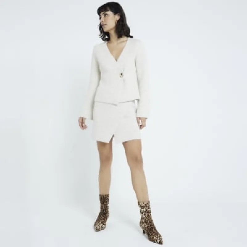 Beige Asymmetrical wrap mini skirt sold by River Island