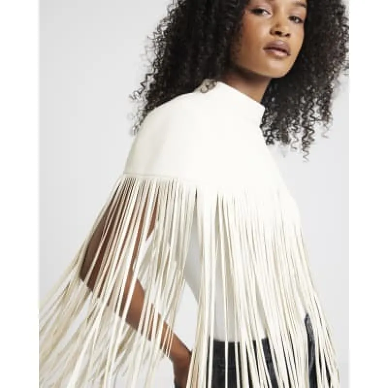 Cream faux leather tassel hem cape sold by River Island