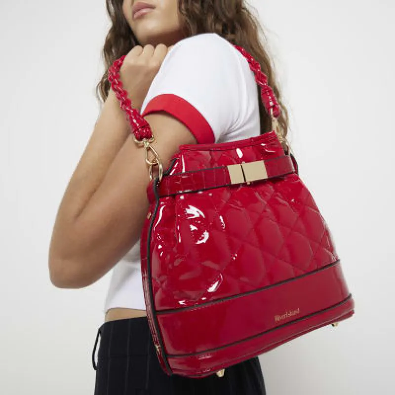 Red patent quilted bucket bag sold by River Island