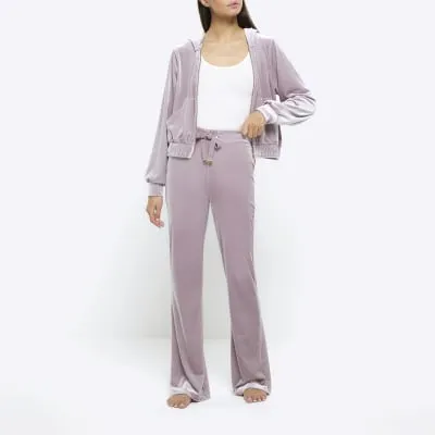Purple velour joggers sold by River Island