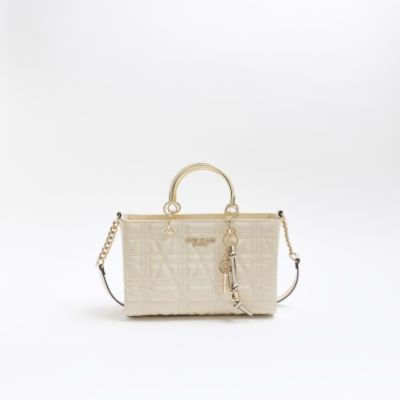 Cream patent tote bag sold by River Island
