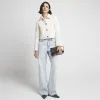 Cream collared crop trophy jacket sold by River Island