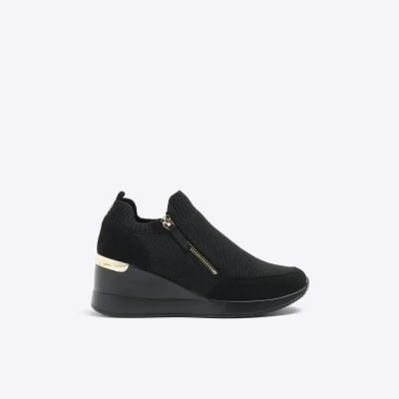 Black slip on wedge trainers sold by River Island