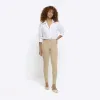 Cream mid rise bum sculpt jeggings sold by River Island