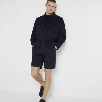 Navy slim fit chino shorts sold by River Island