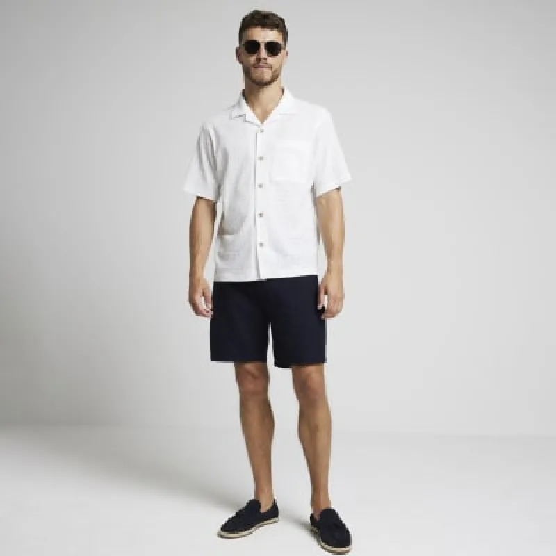 Navy regular fit textured shorts sold by River Island