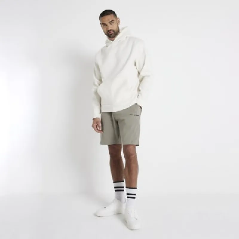 Khaki regular fit embroidered shorts sold by River Island