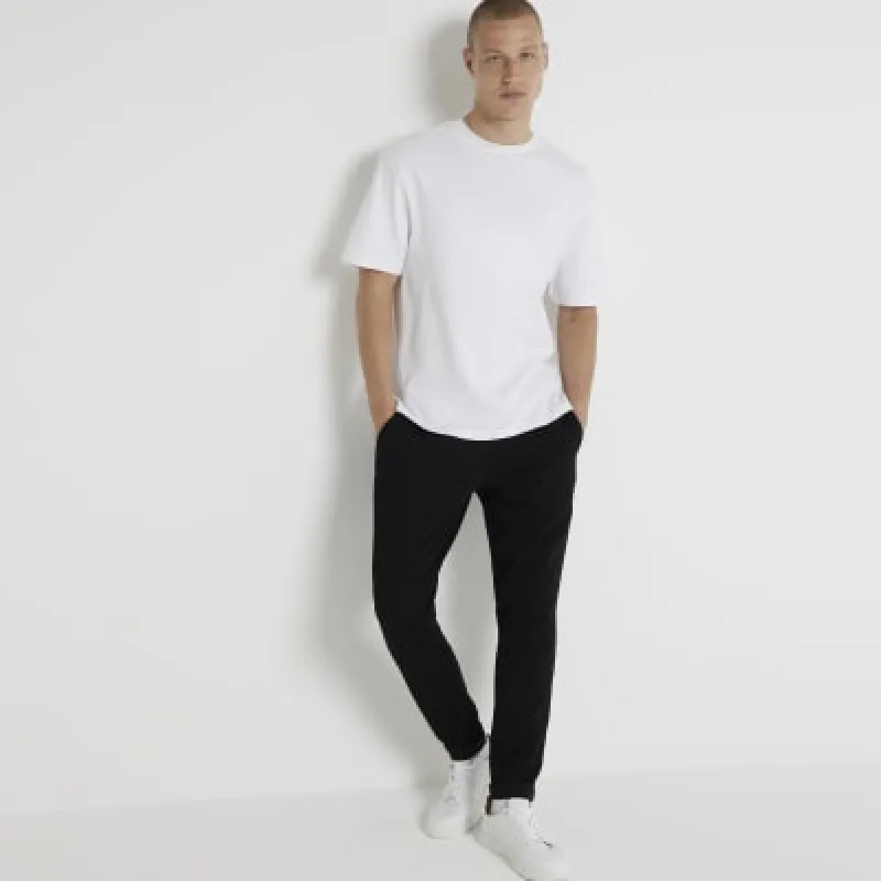 Black skinny fit textured turned hem joggers sold by River Island