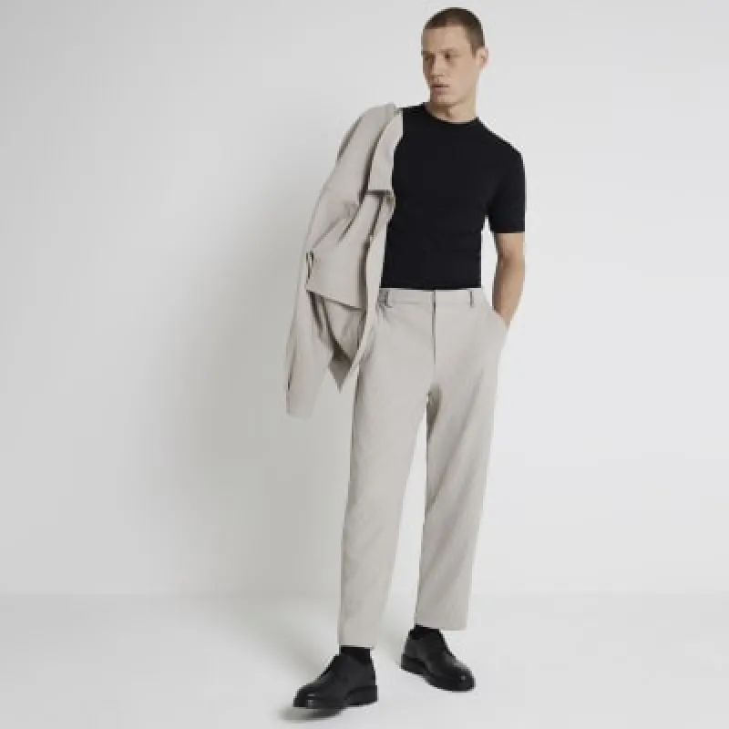 Beige tapered fit plisse smart trousers sold by River Island