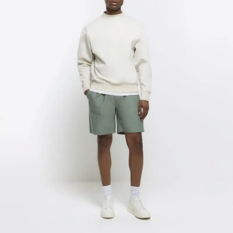 Green regular fit pull on shorts sold by River Island
