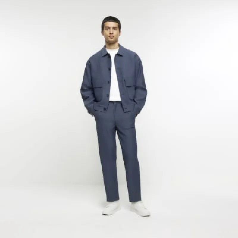 Blue tapered fit plisse smart trousers sold by River Island