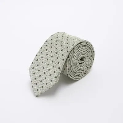 Green polka dot jacquard tie sold by River Island
