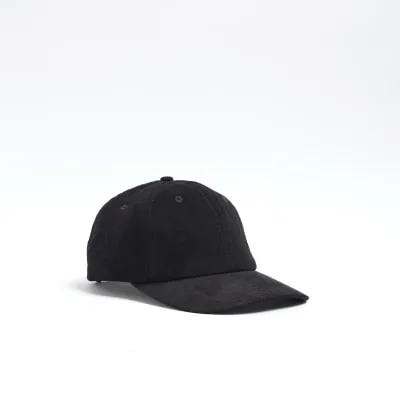Black corduroy flat peak cap sold by River Island