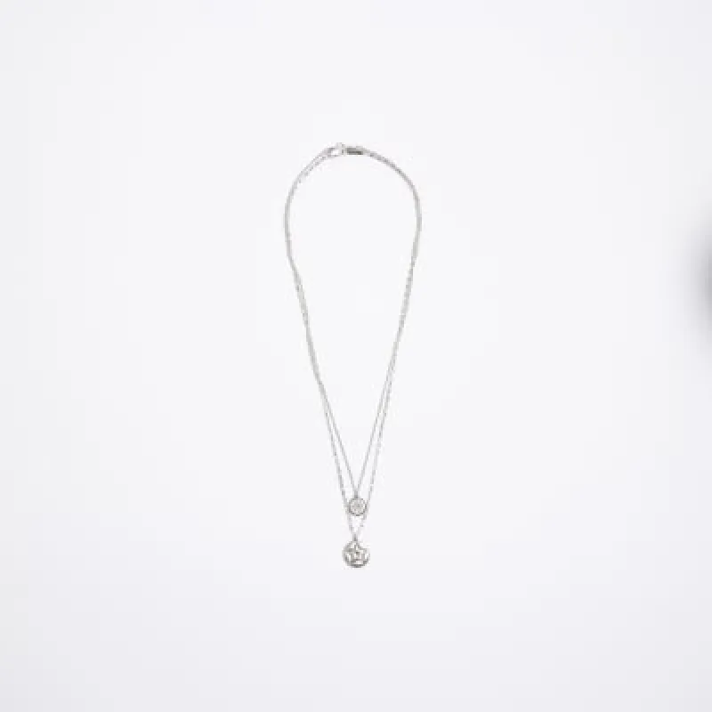 Silver colour star pendant necklace sold by River Island