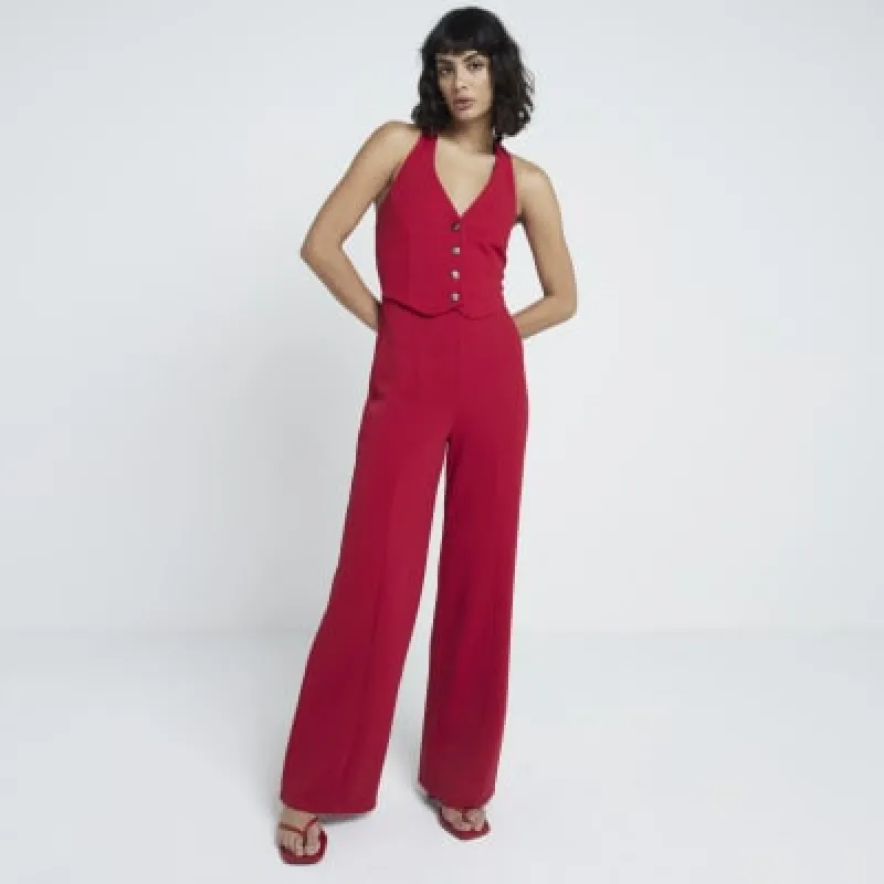 Red halter neck waistcoat jumpsuit sold by River Island