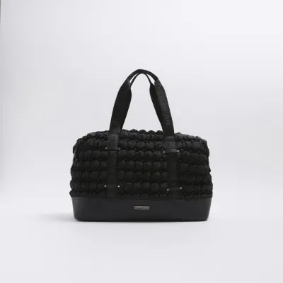 Black quilted texture travel bag sold by River Island
