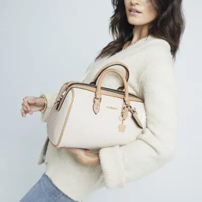 Beige embossed monogram bowler handbag sold by River Island