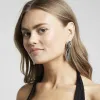 Silver twisted drop earrings sold by River Island