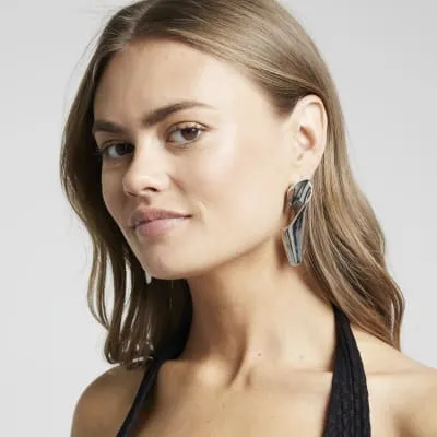 Silver twisted drop earrings sold by River Island