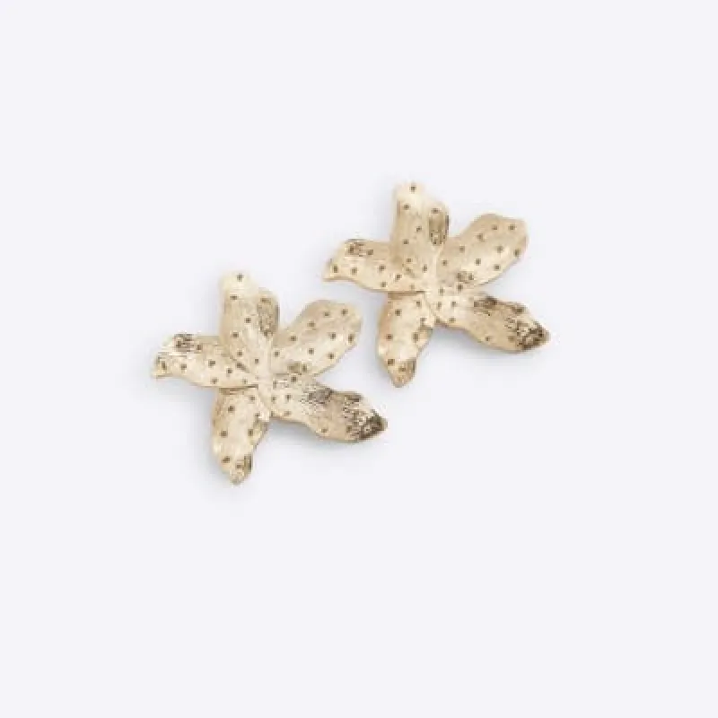 Gold flower stud earrings sold by River Island