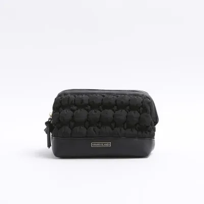 Black quilted makeup bag sold by River Island
