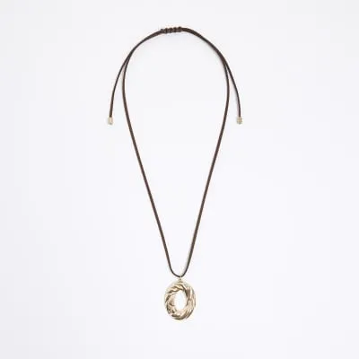 Gold oval pendant necklace sold by River Island