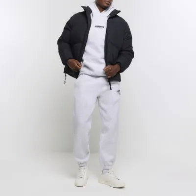 Grey regular fit graphic tracksuit joggers sold by River Island