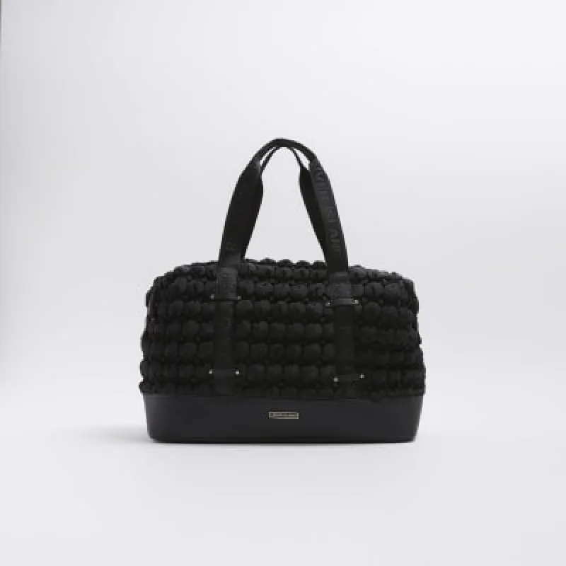 Black quilted texture travel bag sold by River Island