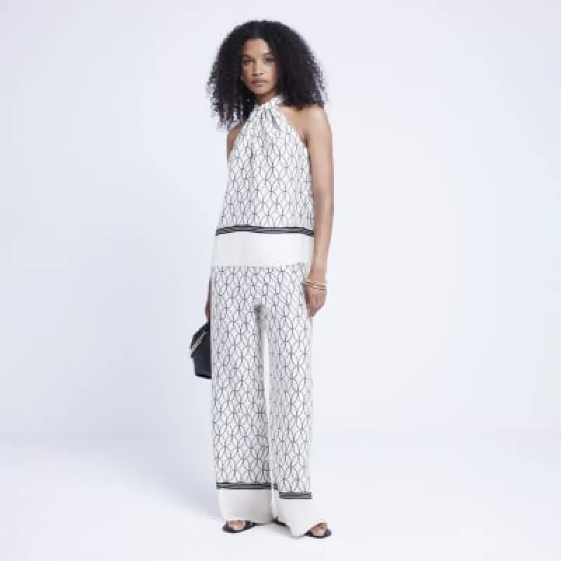 Cream geometric halter neck top sold by River Island