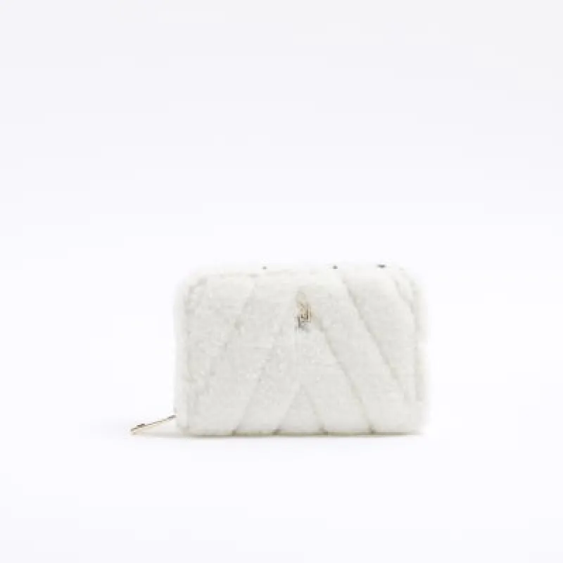 Cream borg quilted purse sold by River Island