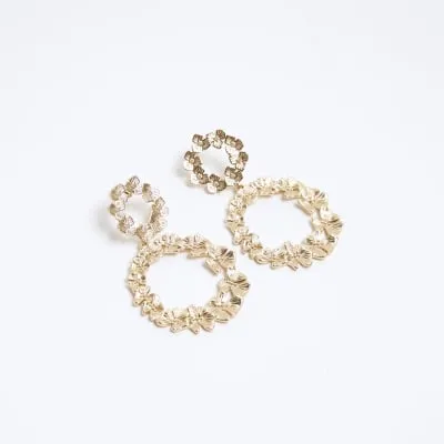 Gold flower open circle drop earrings sold by River Island