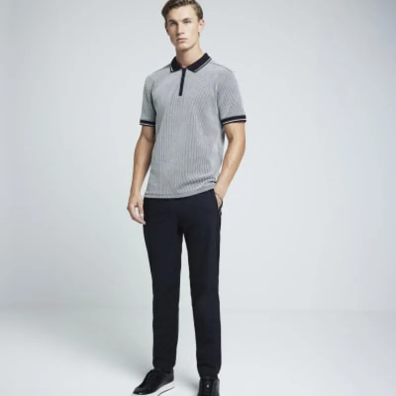 Black slim fit stretch jacquard half zip polo sold by River Island