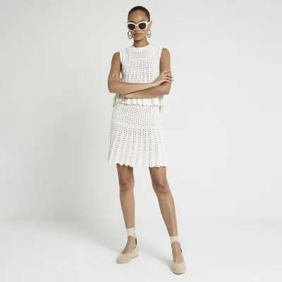 White crochet pleated mini skirt sold by River Island