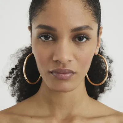 Gold large hoop earrings sold by River Island