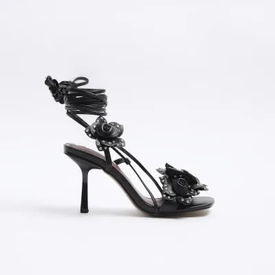 Black flower detail heeled sandals sold by River Island