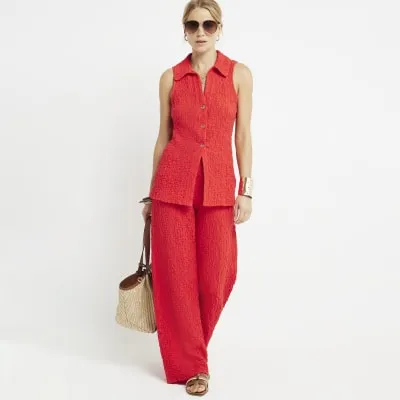 Red textured wide leg trousers sold by River Island