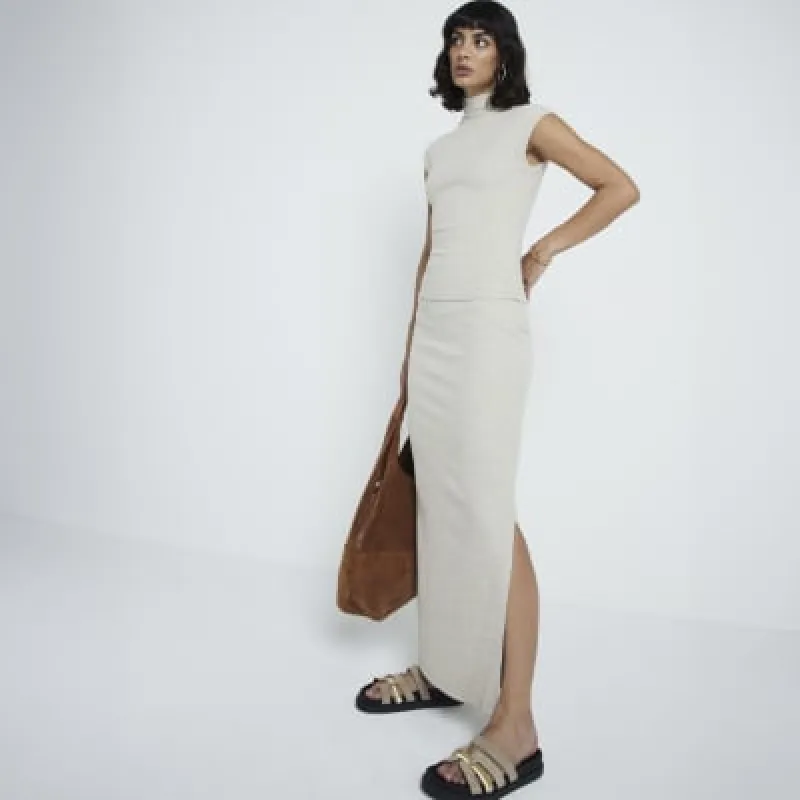 Beige  ribbed roll neck top sold by River Island