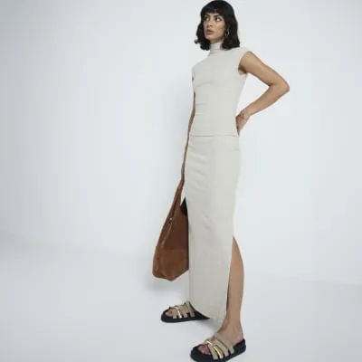 Beige ribbed roll neck top sold by River Island