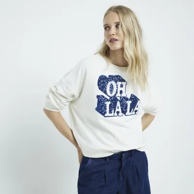 White sequin graphic sweatshirt sold by River Island