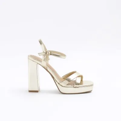 Gold wide fit crossed strap heeled sandals sold by River Island