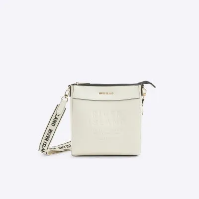 Cream embossed cross body bag sold by River Island