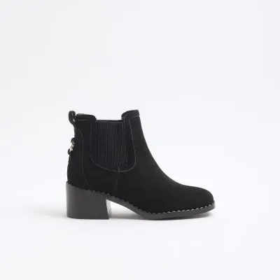 Black suede block heeled ankle boots sold by River Island