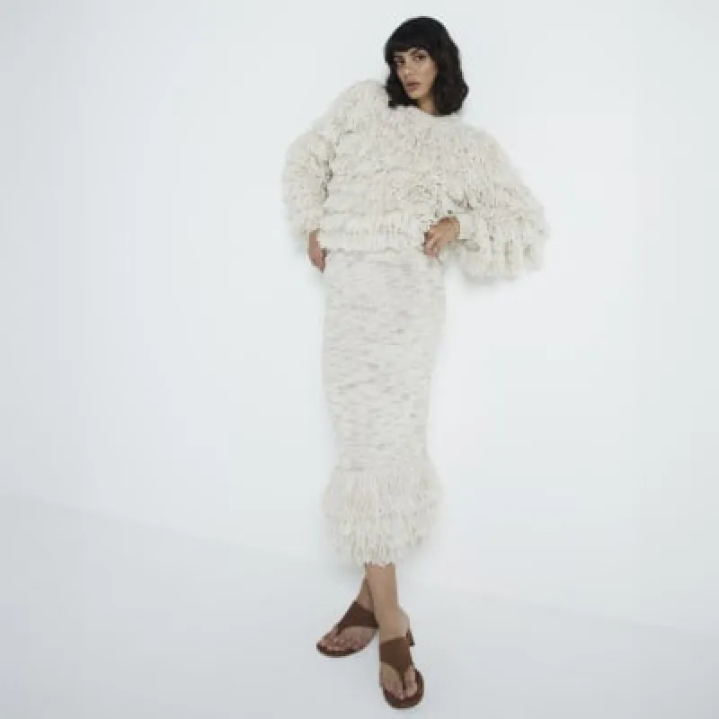 Cream knit fringe midi skirt sold by River Island
