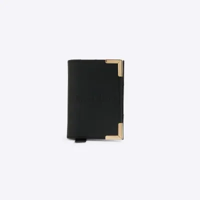 Black embossed passport holder sold by River Island