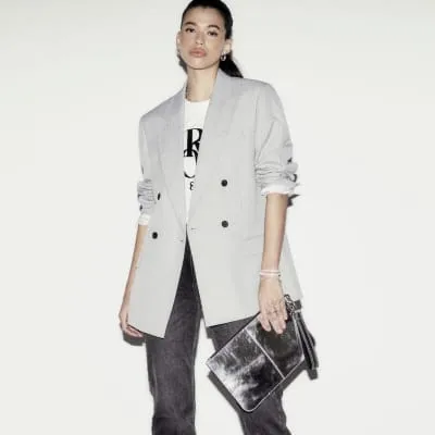 Silver metallic leather clutch bag sold by River Island