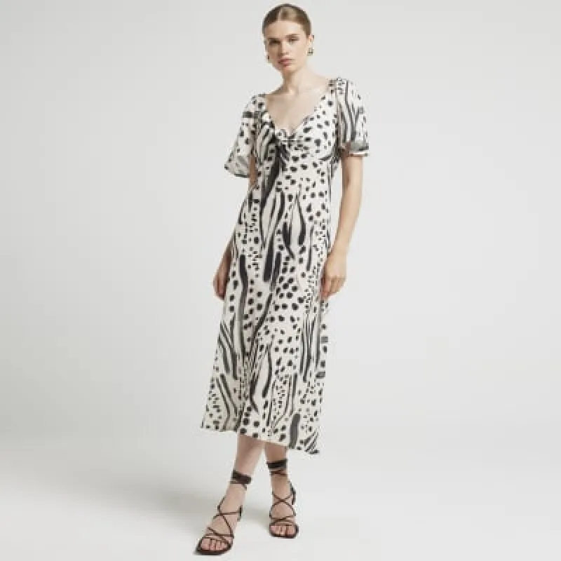 Cream abstract tie front swing midi dress sold by River Island