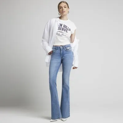 Blue mid rise flared jeans sold by River Island