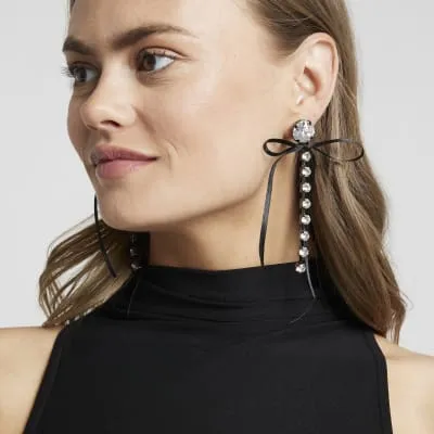Black diamante bow drop earrings sold by River Island