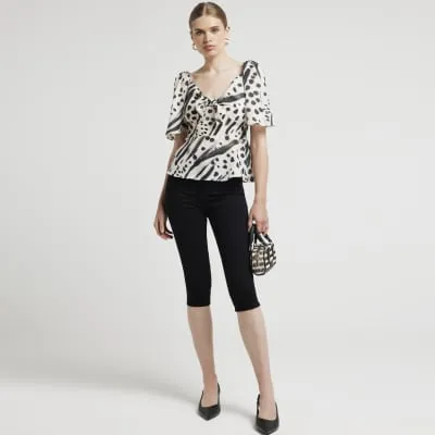 Cream abstract tie front blouse sold by River Island